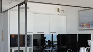 A compact kitchenette with a microwave, coffee maker, and a small sink. - Résidence Victoria Surf (Biarritz)