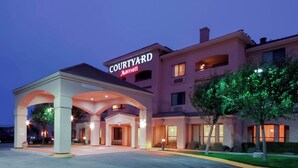 A Courtyard Marriott hotel with a covered entrance and multiple floors.