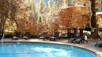 Een buitenzwembad, parasols voor strand/zwembad