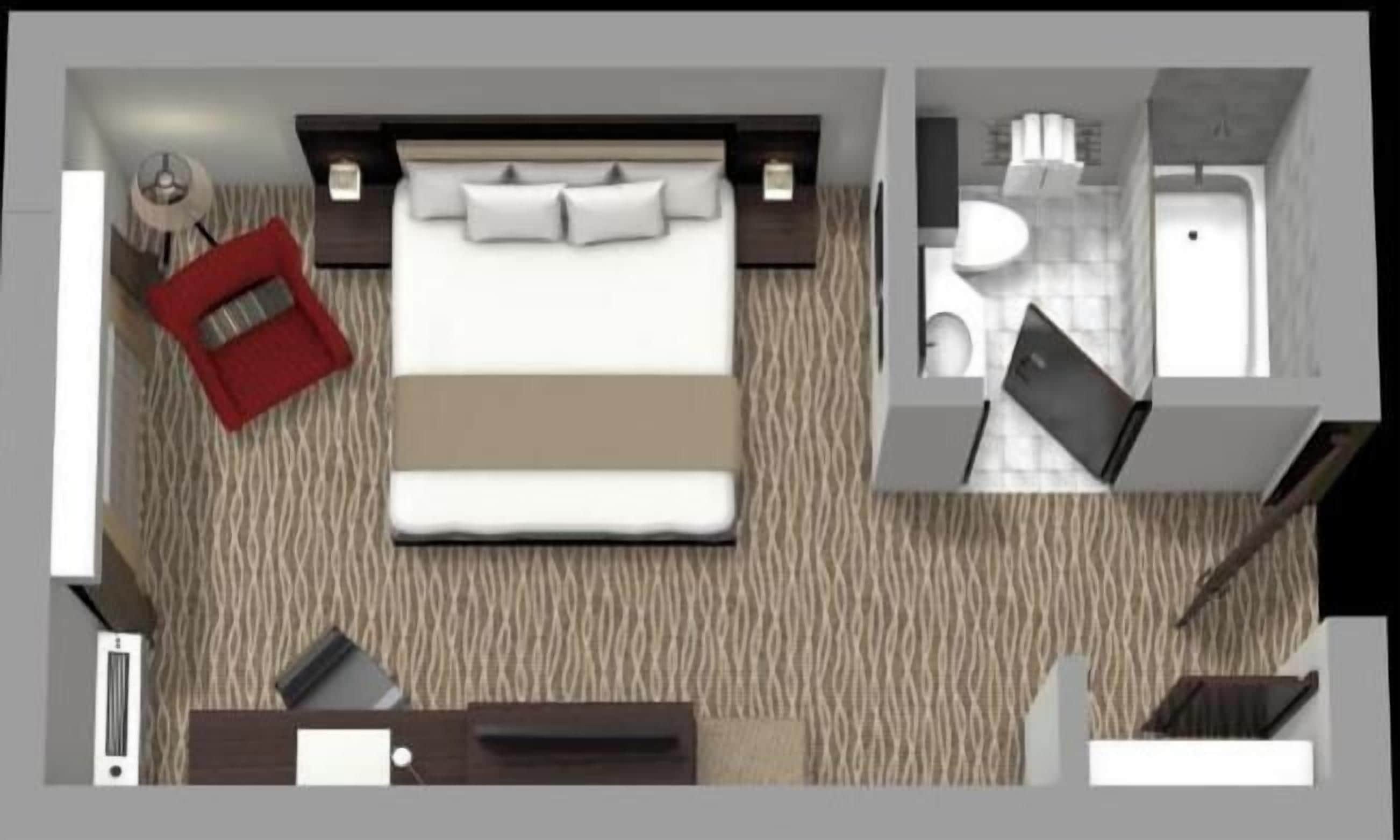 A hotel room with a bed, a desk, a chair, a red sofa, a bathroom with a sink and toilet, and a shower.