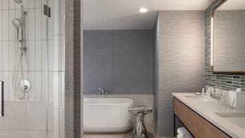 A modern bathroom with a freestanding bathtub, a shower with multiple heads, and a vanity with a mirror.