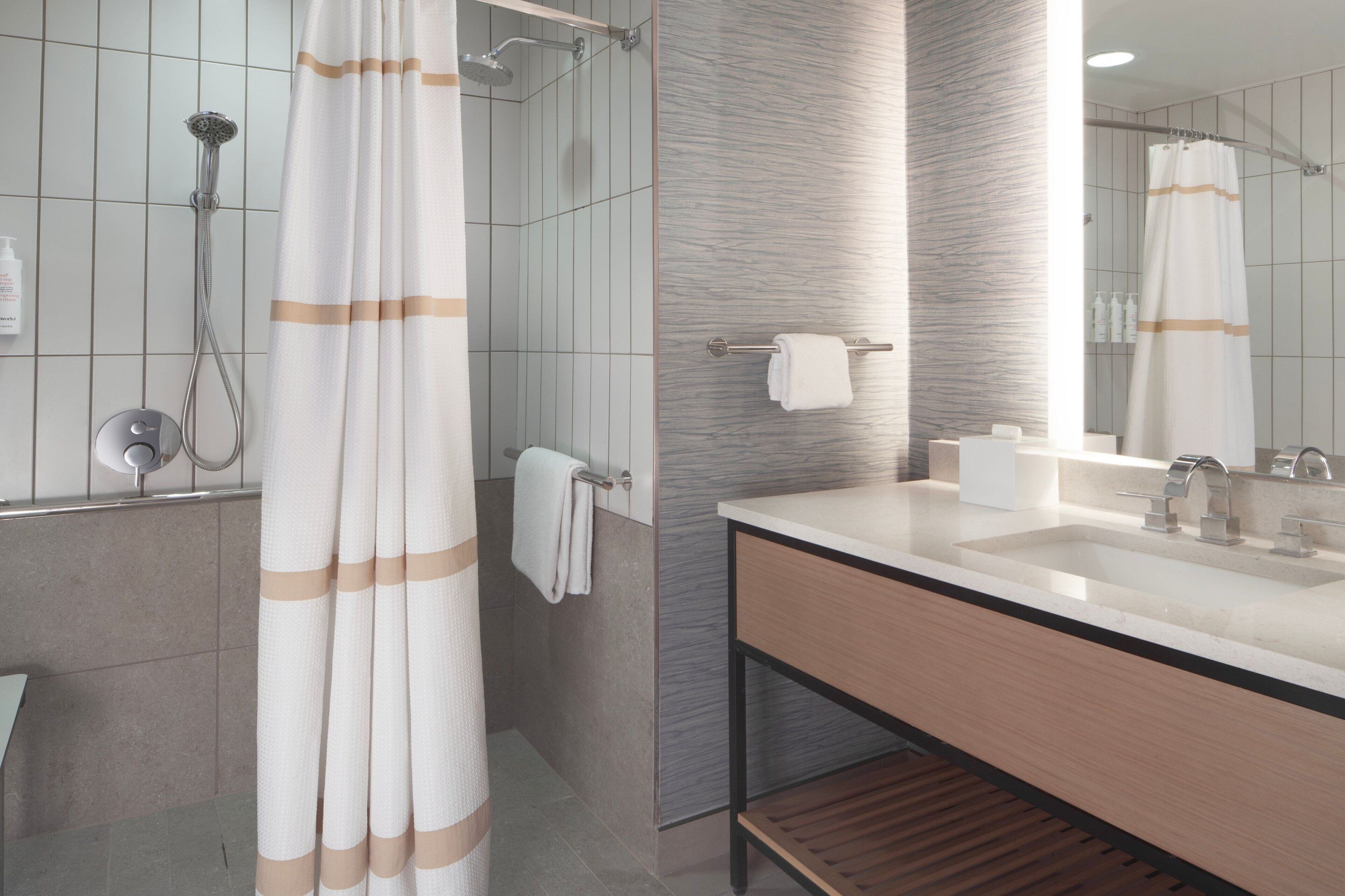 Combined shower/bathtub, designer toiletries, hair dryer, bathrobes