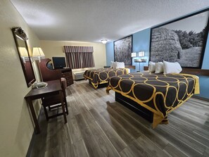 A hotel room with two beds, a desk, a chair, a TV, and a large window with a view of trees. - Super 8 by Wyndham Clinton OK (Clinton)