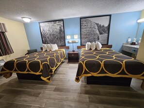 A hotel room with two beds, a nightstand, a desk, and a large window. - Super 8 by Wyndham Clinton OK (Clinton)