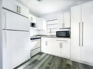 Standard Room, 2 Double Beds | Private kitchen | Full-sized fridge, microwave, oven, stovetop