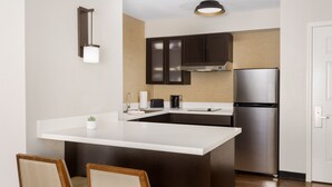 A modern kitchen with a central island, dark cabinetry, and stainless steel appliances. - Residence Inn by Marriott Salinas Monterey (Salinas)