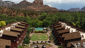 A hotel with multiple buildings, a swimming pool, and a mountainous backdrop. - Amara Resort and Spa (Sedona)