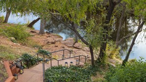 A stone staircase leading down to a body of water, surrounded by greenery and trees. - Amara Resort and Spa (Sedona)