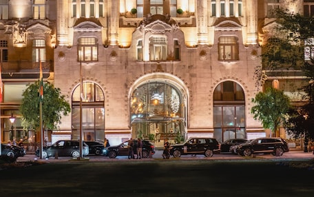 A grand building with ornate architecture, large arched windows, and a prominent entrance.