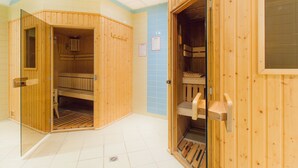 A sauna room with wooden walls and a tiled floor.