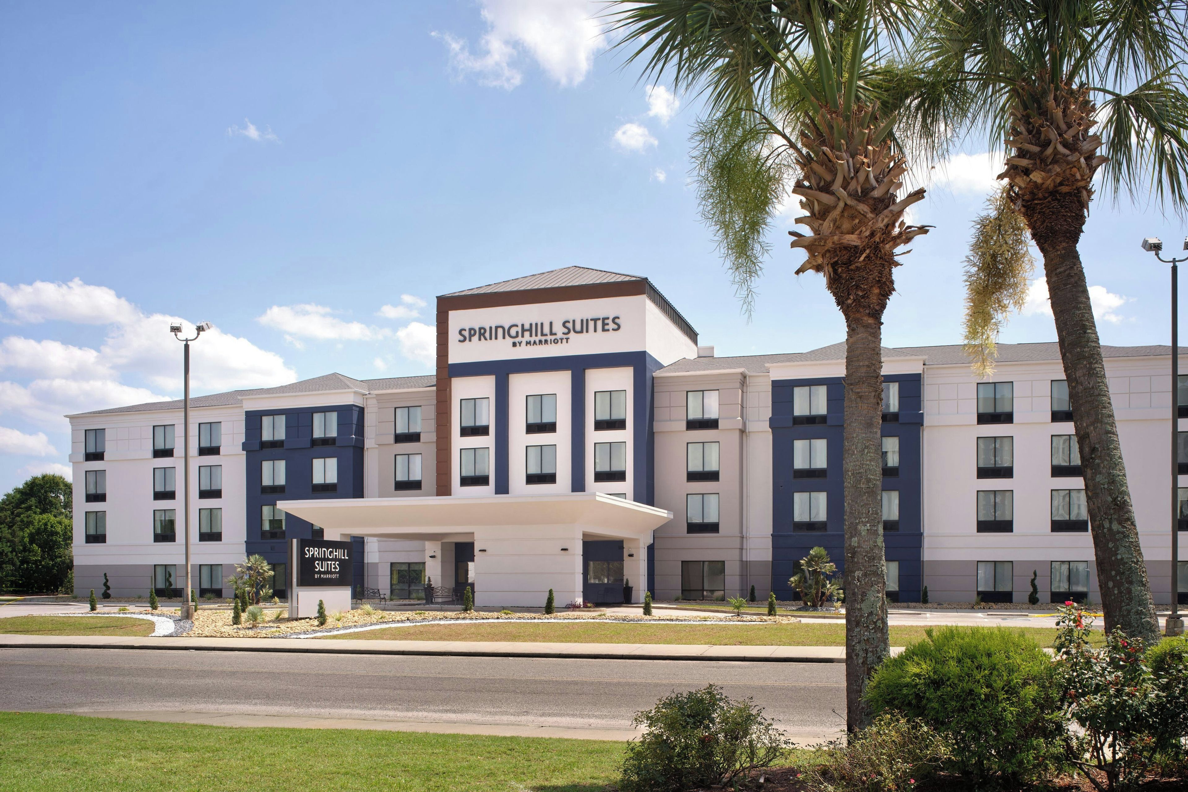A multi-story hotel with a prominent signage for Springhill Suites by Marriott.