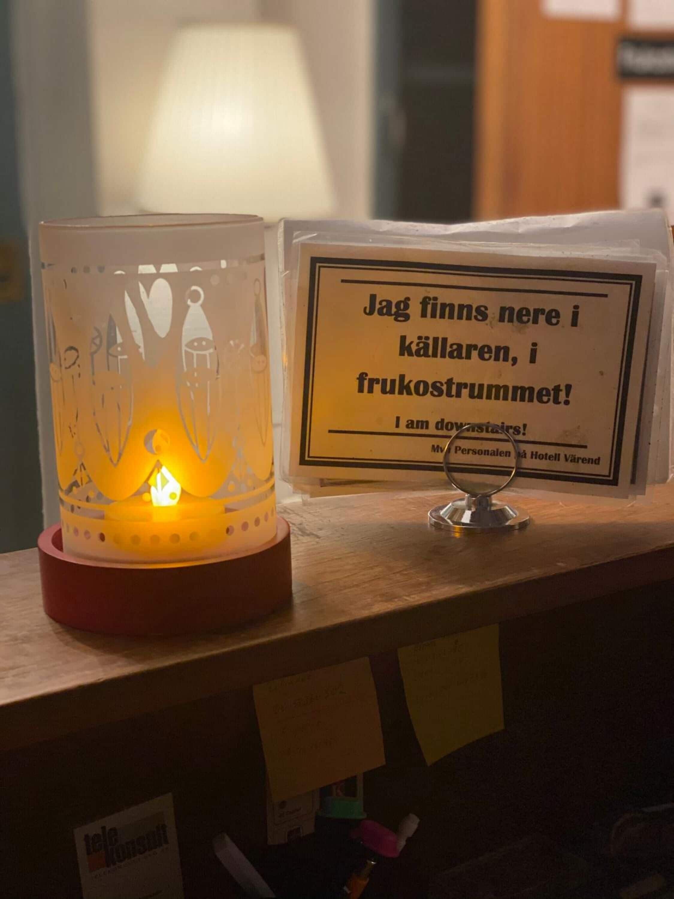Uma vela com uma placa em frente.