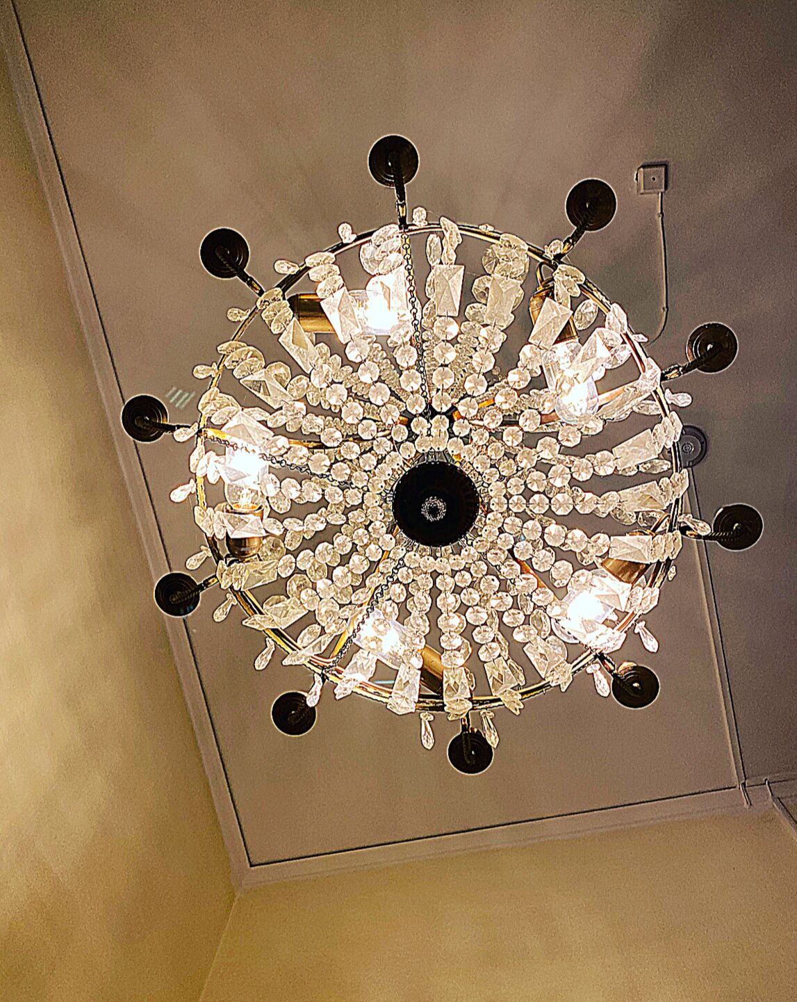 A chandelier with multiple crystal elements and black accents.