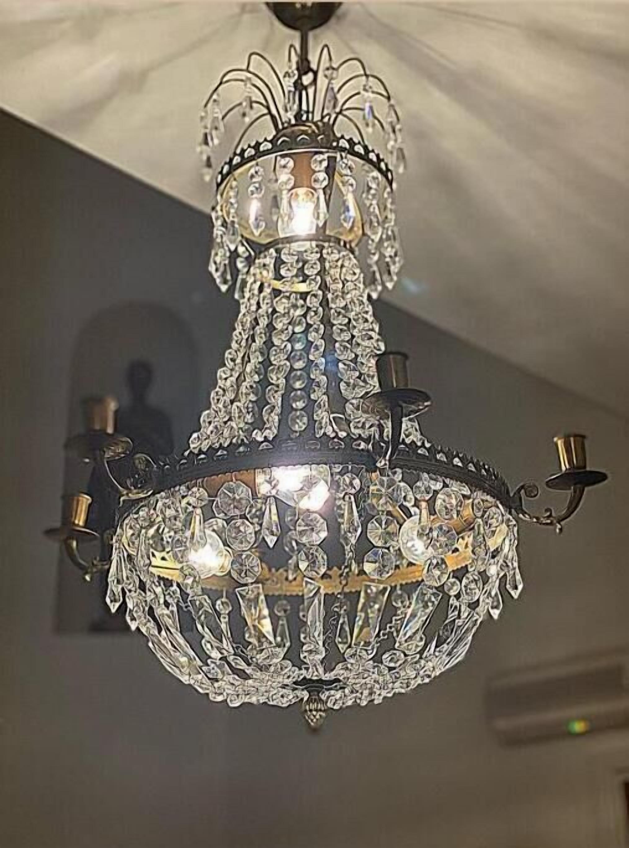 A chandelier with multiple tiers and crystal decorations.