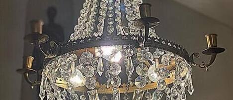 A chandelier with multiple tiers and crystal decorations.