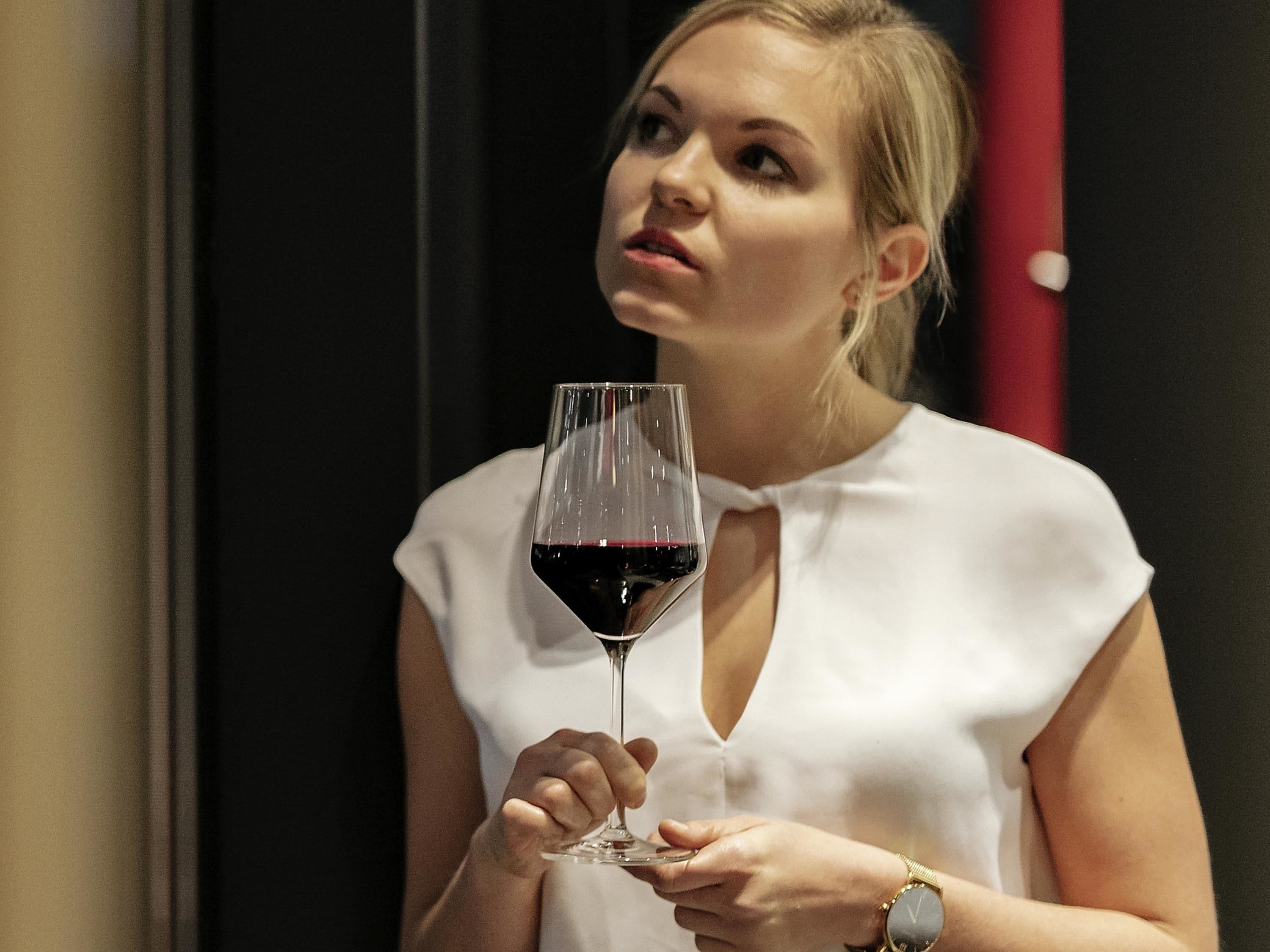 A person holding a wine glass.