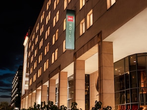 A modern hotel building with a prominent 'ibis HOTEL' sign, large windows, and a structured facade. - ibis Warszawa Stare Miasto Old Town (Warsaw)