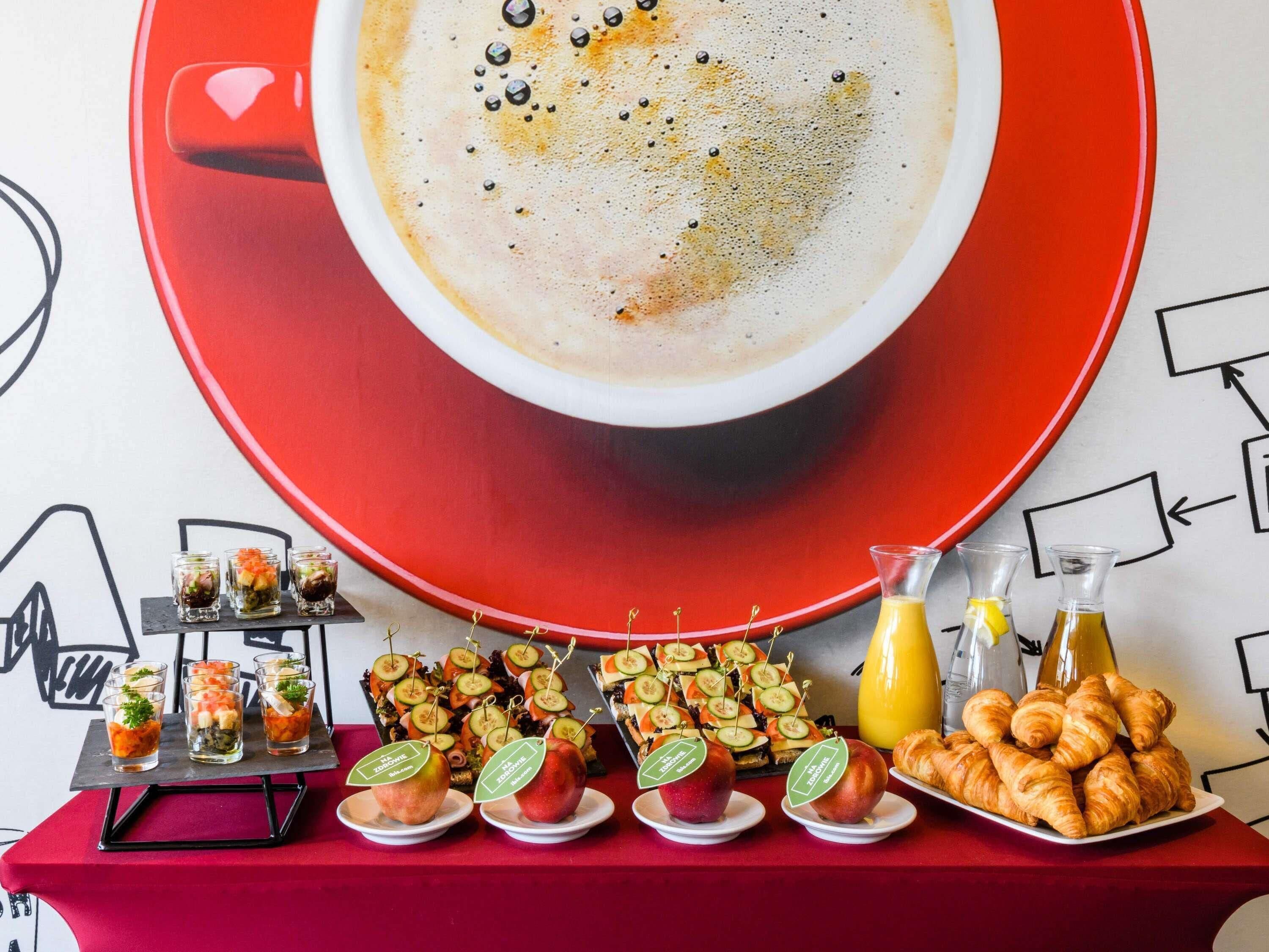A breakfast buffet with various food items and a cup of coffee.