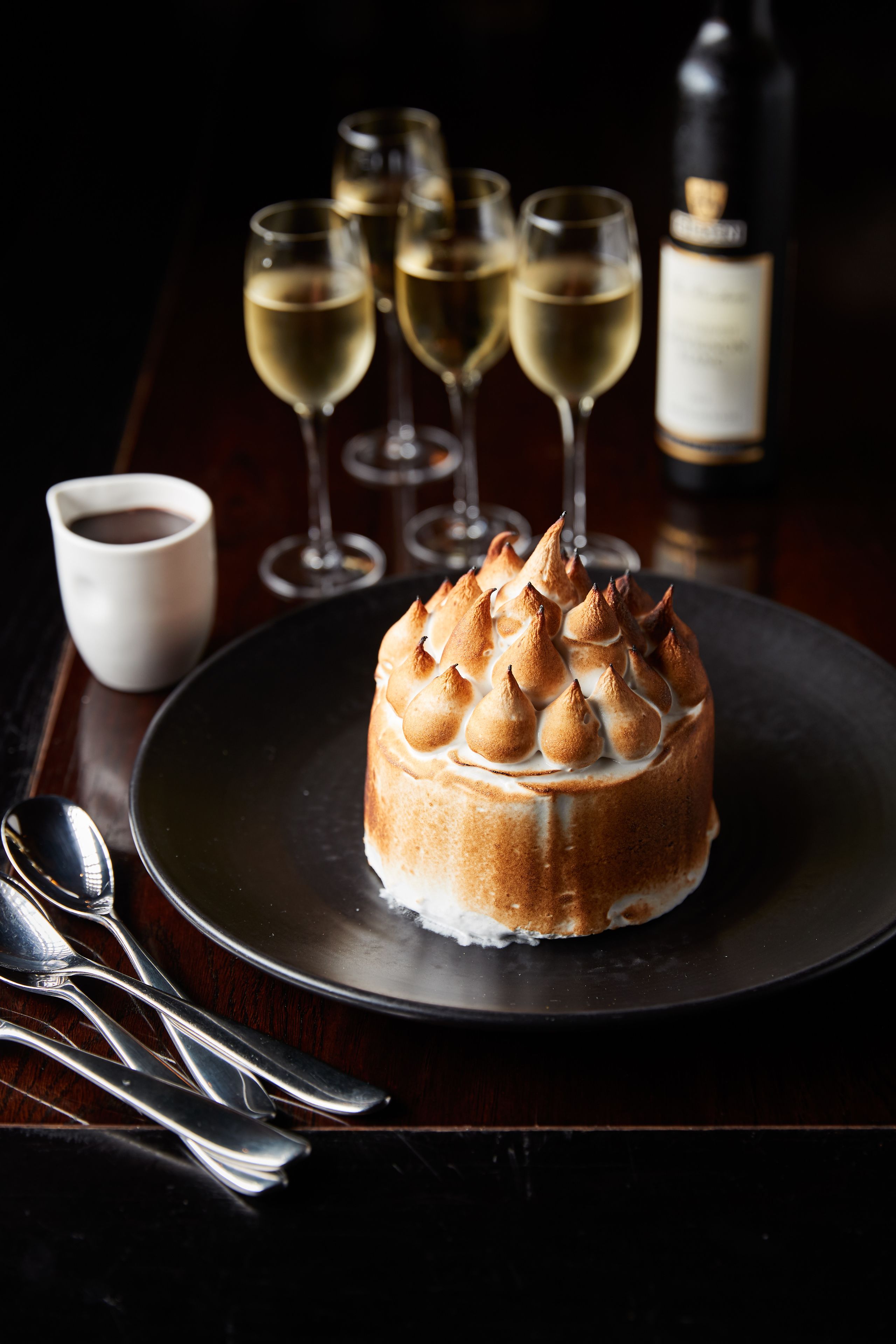 A dessert on a plate with a dark background.