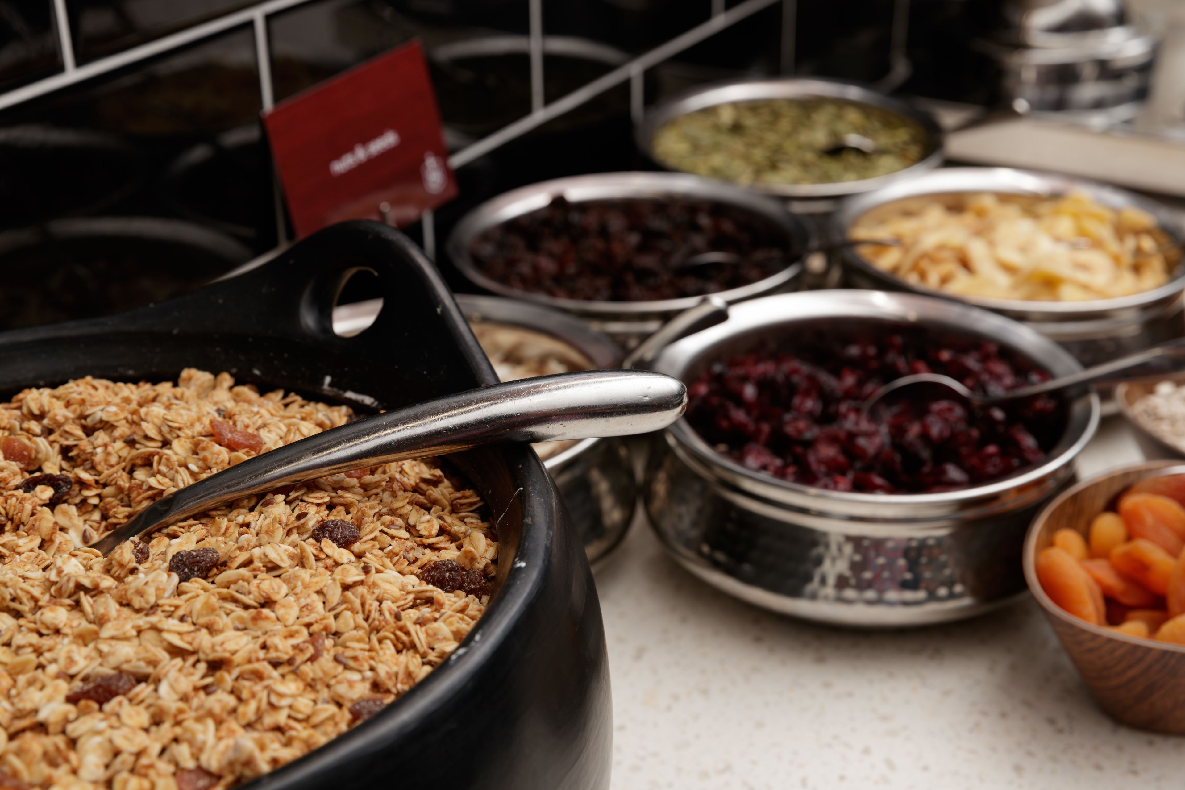 A variety of food items in metal containers on a counter.