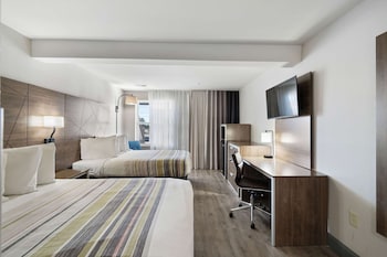 Premium bedding, desk, laptop workspace, blackout drapes at Country Inn & Suites by Radisson, Myrtle Beach, SC
