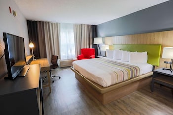 Premium bedding, desk, laptop workspace, blackout drapes at Country Inn & Suites by Radisson, Myrtle Beach, SC