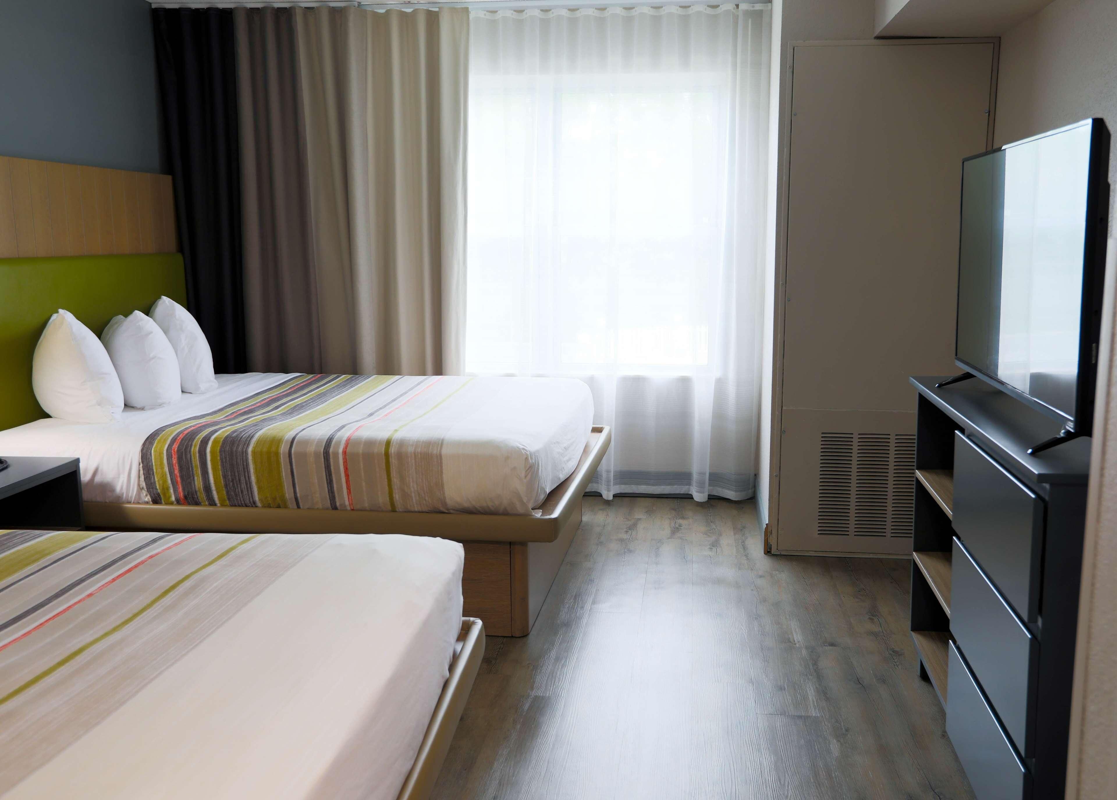 Premium bedding, desk, laptop workspace, blackout drapes