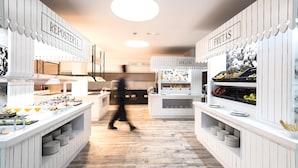 A modern, well-lit food station with labeled sections for 'REPOSTERIA' and 'FRUTAS'. - Barceló Teguise Beach - Adults only (Teguise)