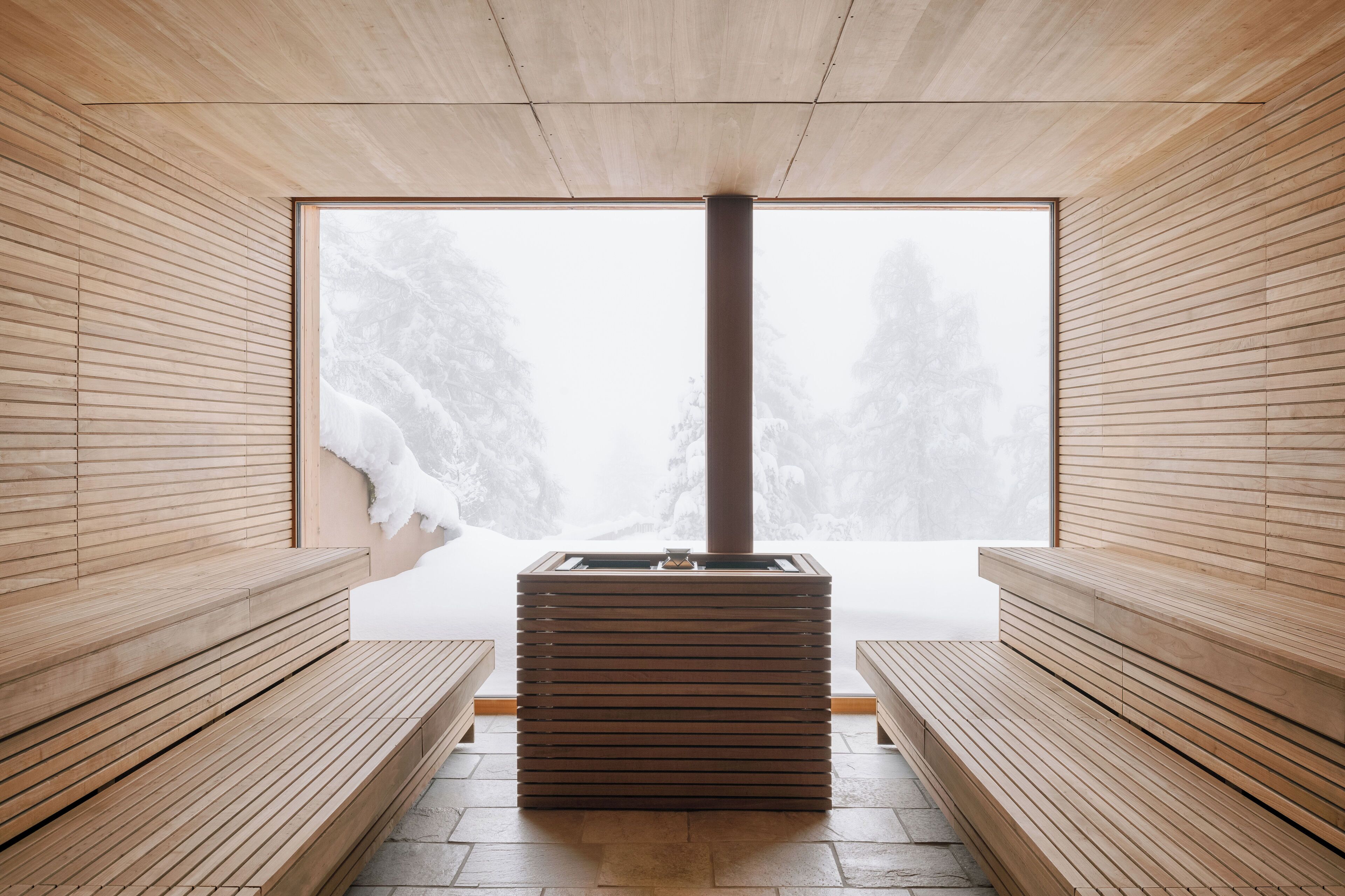 A sauna room with wooden benches and a large window.