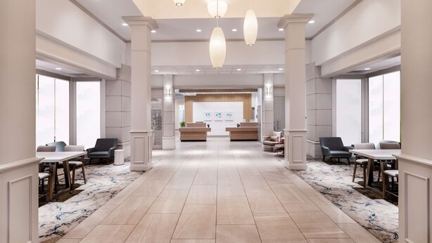 A spacious lobby with a reception desk, seating area, and large windows. - Hilton Garden Inn Jacksonville Ponte Vedra Sawgrass (Ponte Vedra Beach)