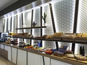 A buffet with various food items and condiments. - ibis Styles A Coruña (A Coruña)