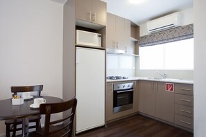 Fridge, microwave, coffee/tea maker, cookware/dishes/utensils