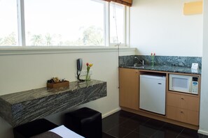 Fridge, microwave, coffee/tea maker, cookware/dishes/utensils