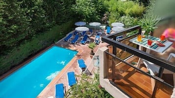 Seasonal outdoor pool, pool umbrellas, pool loungers
