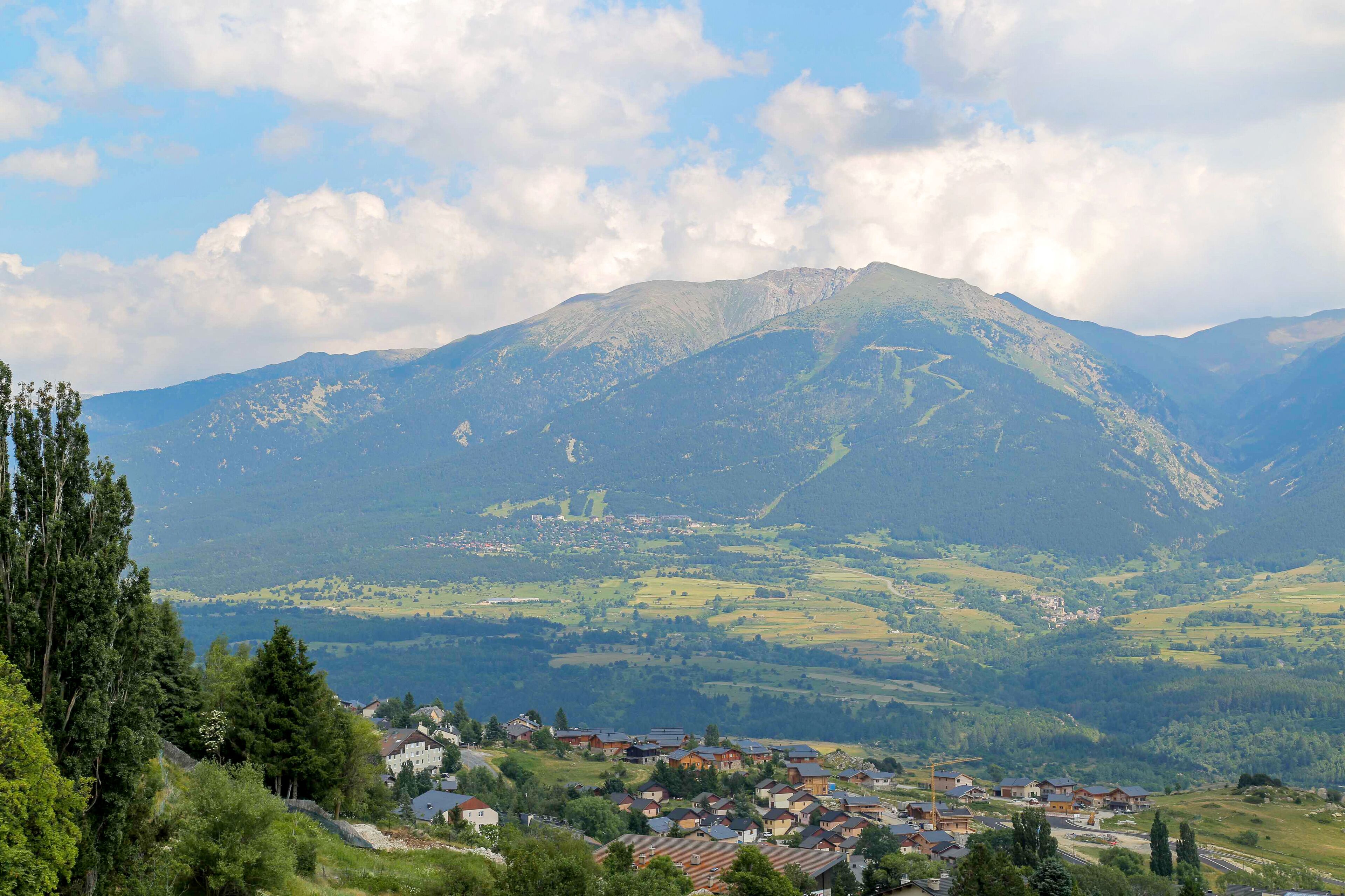 A mountainous landscape with a village in the foreground.