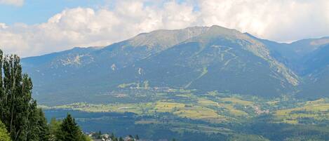 A mountainous landscape with a village in the foreground.