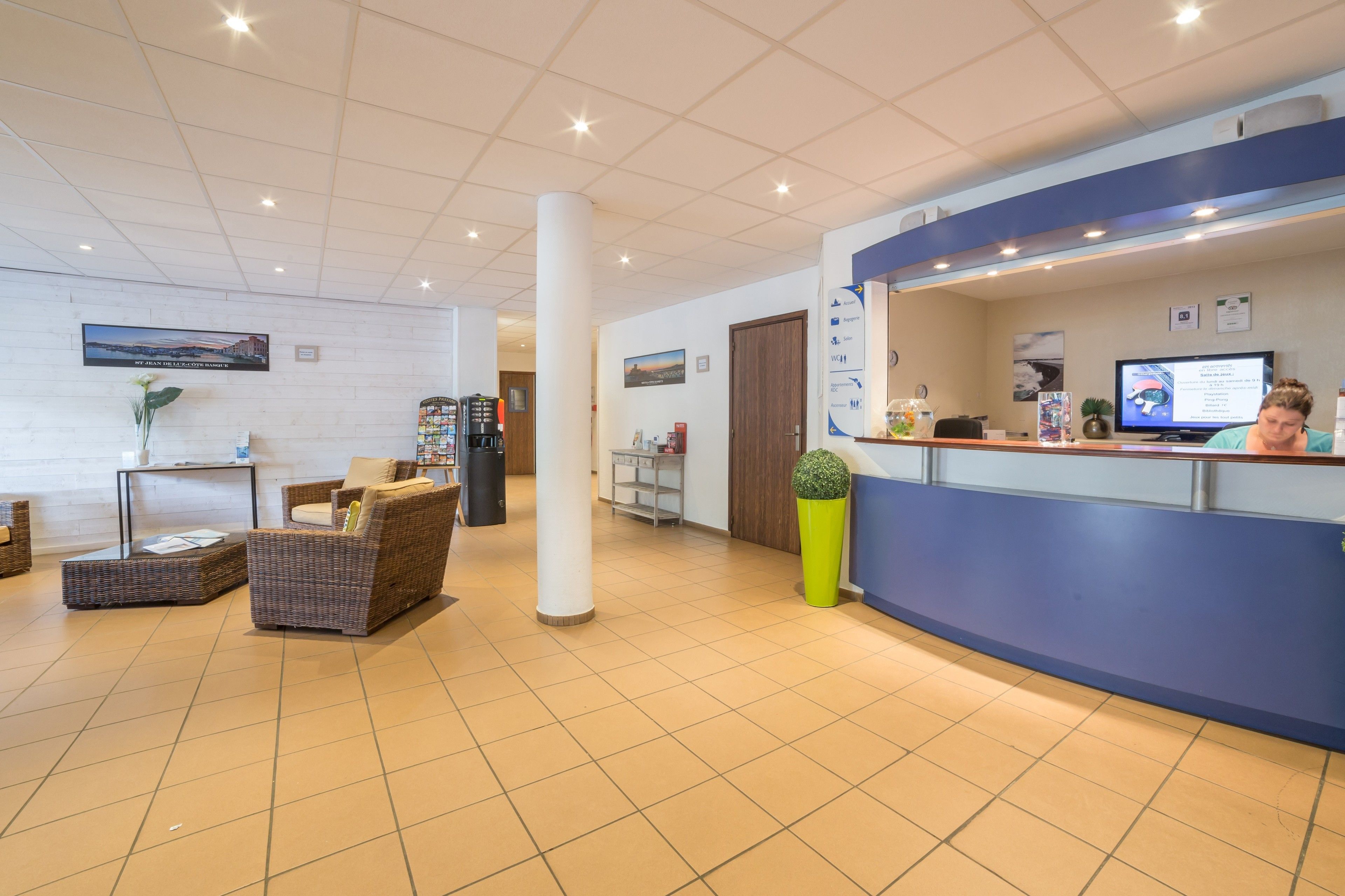 A reception area with a counter, seating, and a large window.