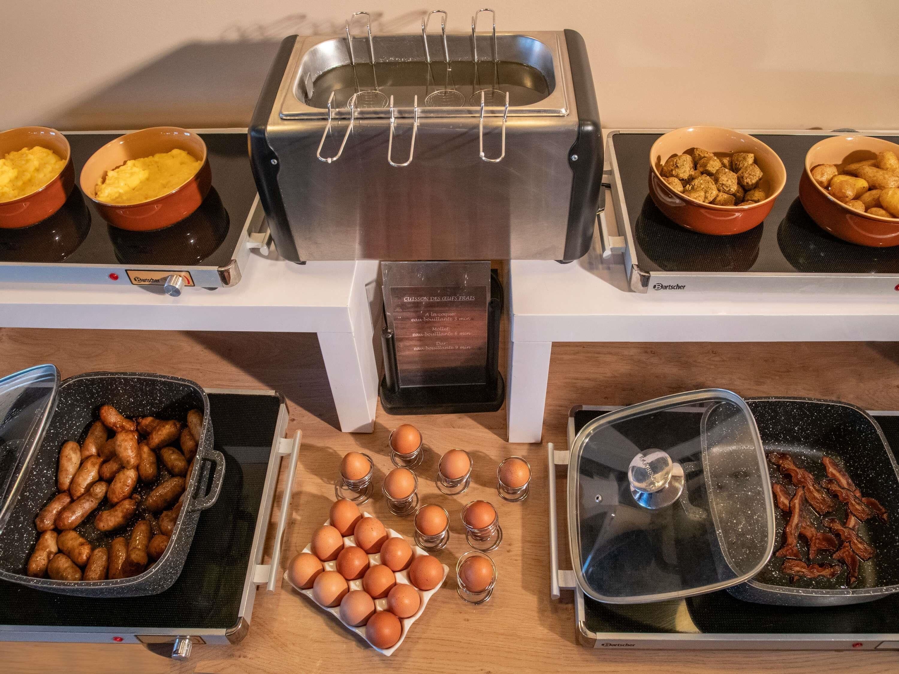 A buffet setup with various food items and a toaster.