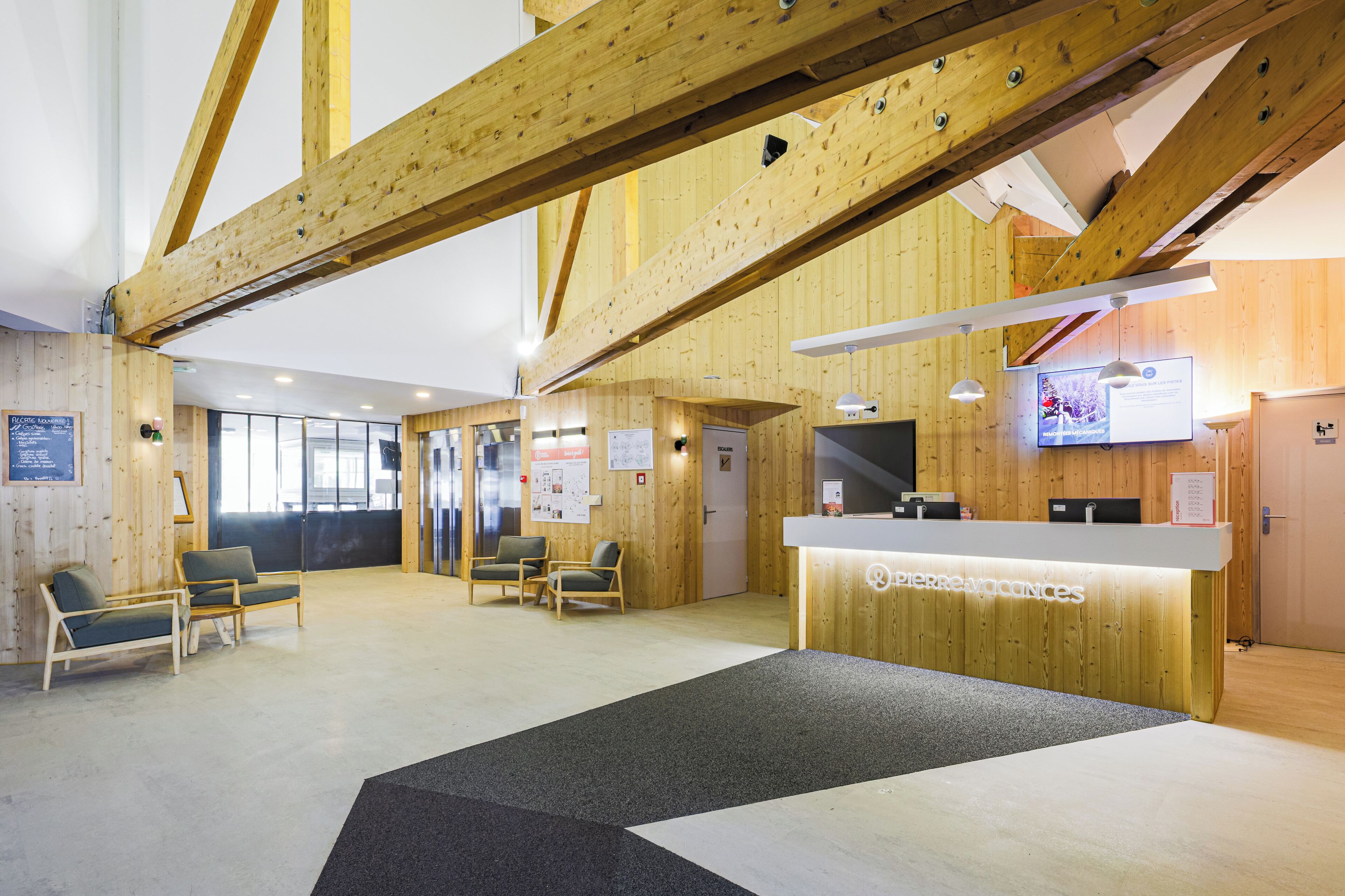 A reception area with wooden walls, a reception desk, and seating.