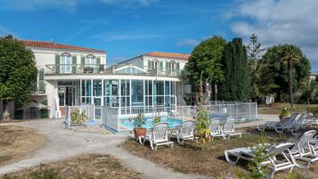 Indoor pool, open 9:00 AM to 7:00 PM, pool loungers