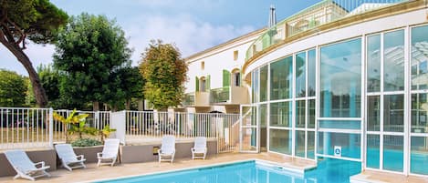 Indoor pool, open 9:00 AM to 7:00 PM, pool loungers