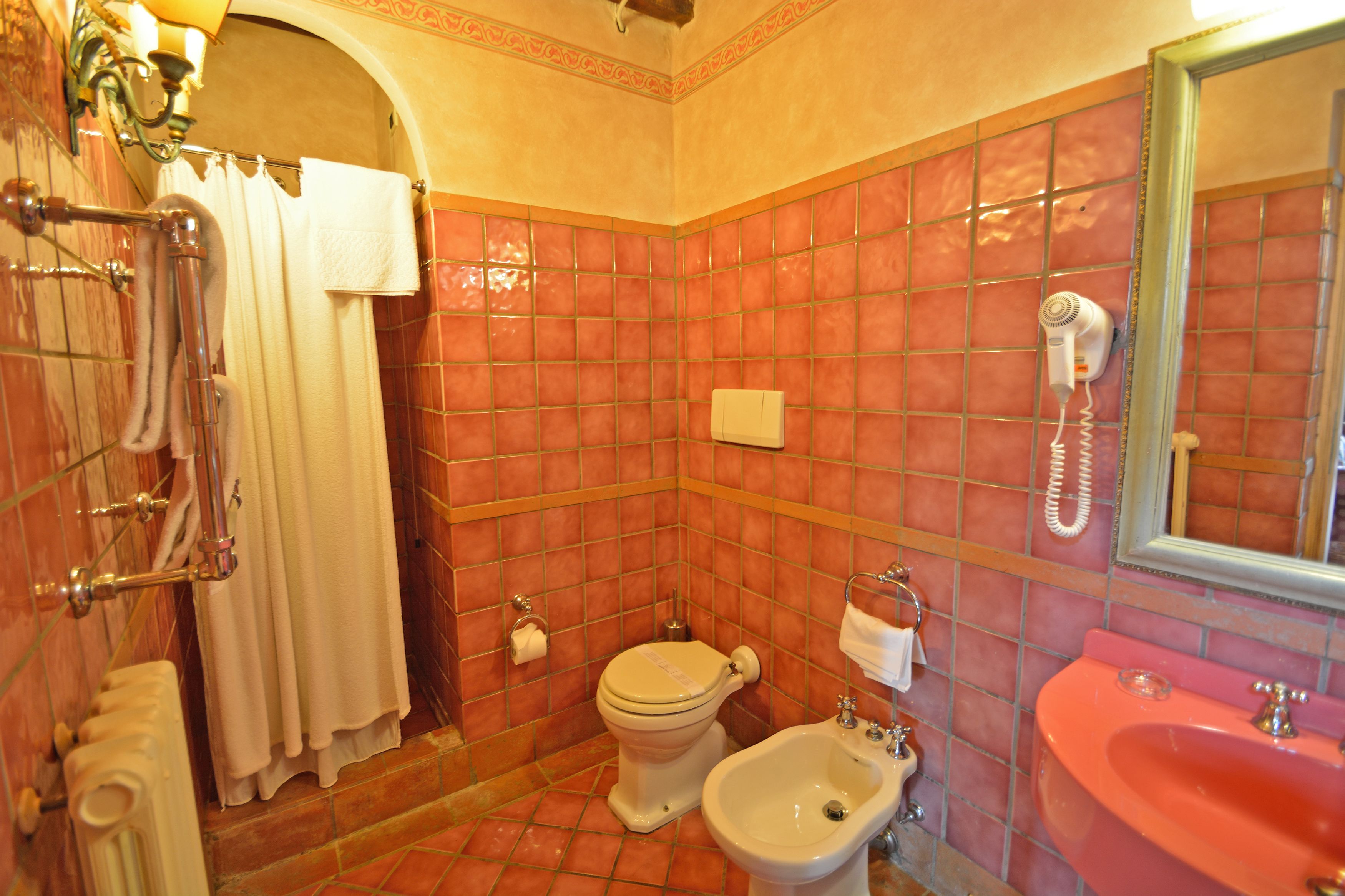combined shower/bathtub, designer toiletries, hair dryer, slippers