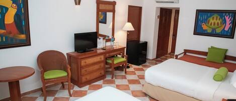 A hotel room with a bed, a desk with a chair, a television, a mirror, and a painting on the wall.