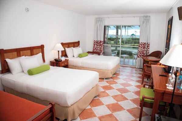 A hotel room with two beds, a desk, and a chair. - Grand Decameron Panama, A Trademark Resort (Rio Hato)