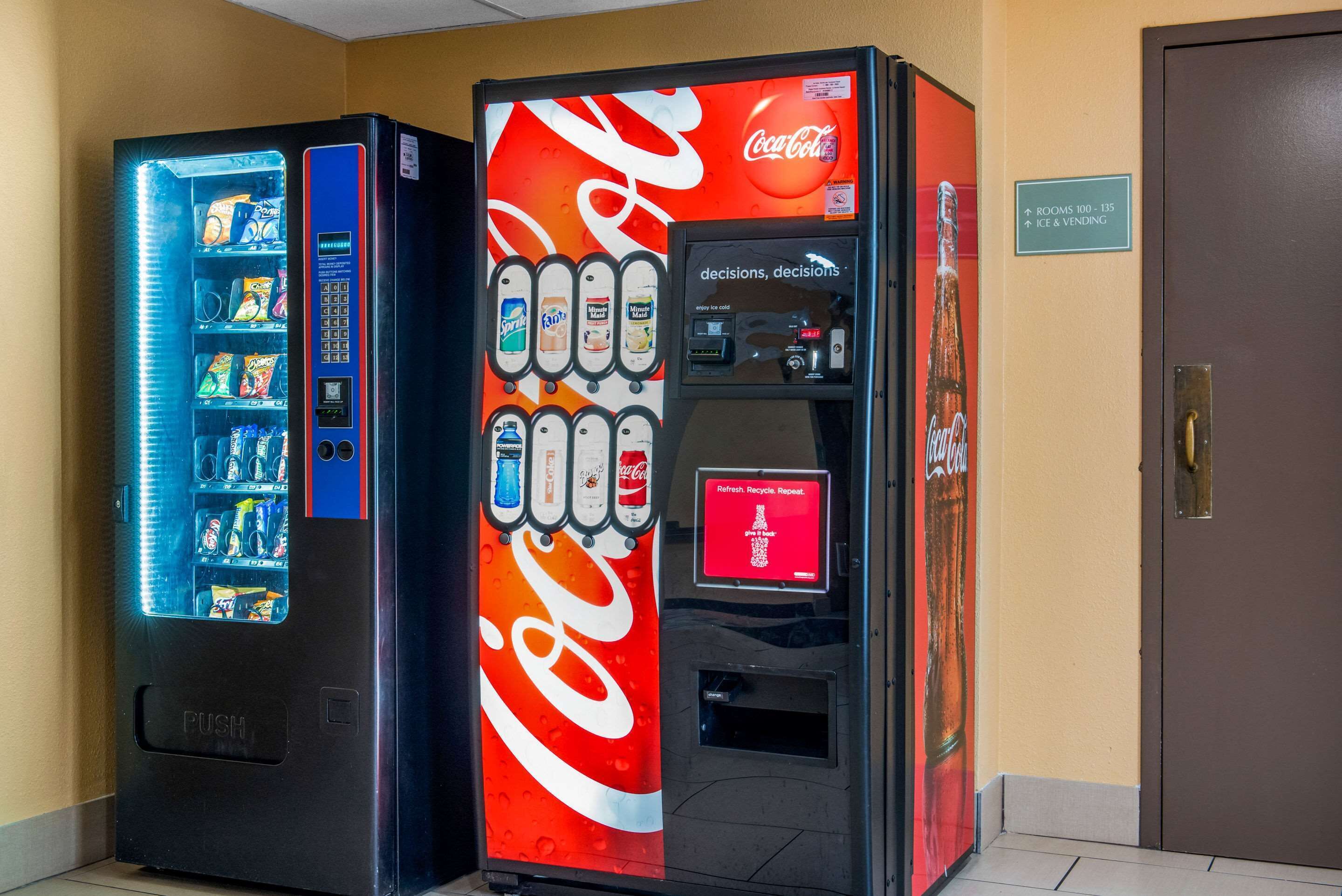 Two vending machines, one with a Coca-Cola logo and another with a blue light.