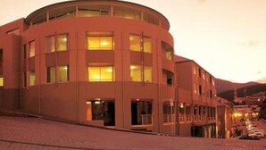 A modern building with a curved facade and multiple windows. - Salamanca Terraces (Battery Point)