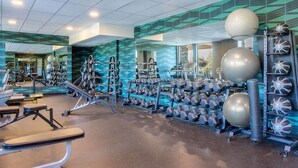 A gym with various exercise equipment, including dumbbells, exercise balls, and a rowing machine. - Days Inn & Suites by Wyndham West Edmonton (Edmonton)