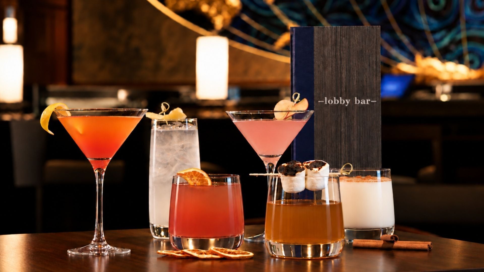 A variety of cocktails and a bar setting with a sign that reads 'lobby bar'.