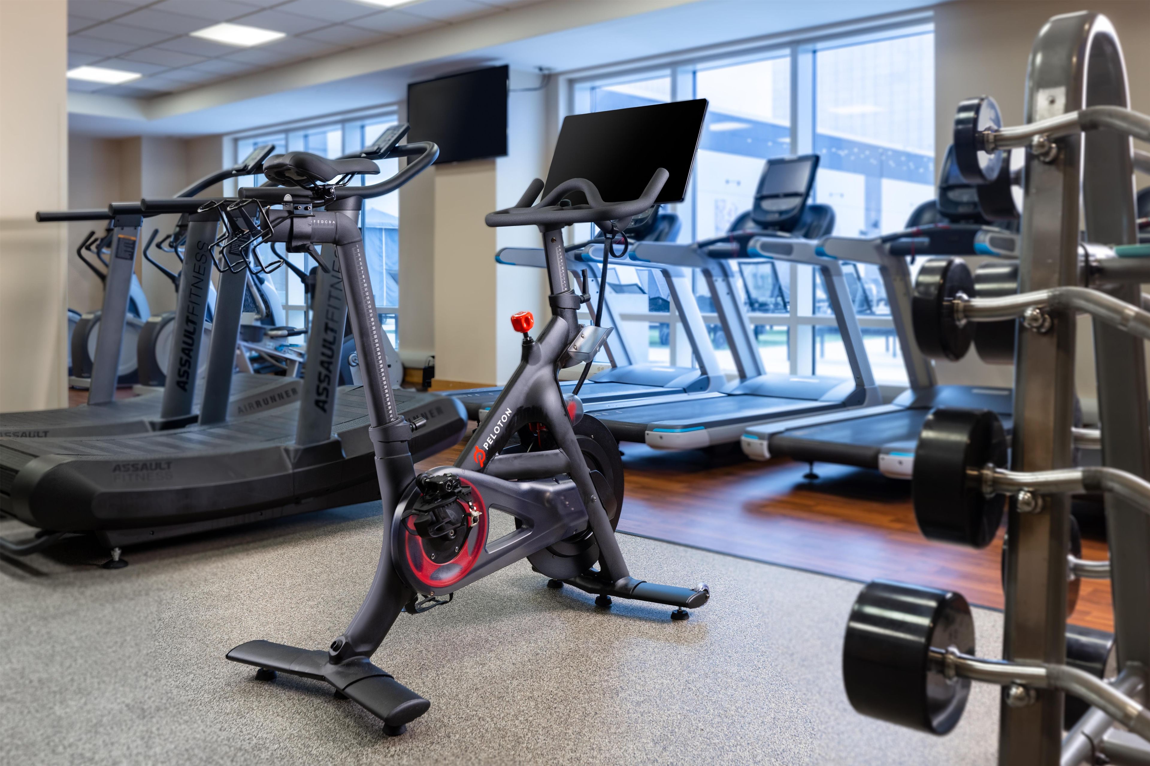 A gym with stationary bikes, treadmills, and weight machines.
