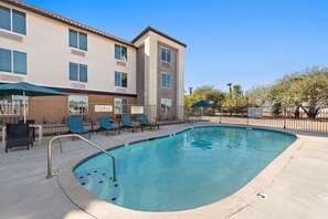 Outdoor pool, open 10:00 AM to 10 PM, pool umbrellas